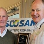 two people shaking hands upon receipt of Soosan dealer award